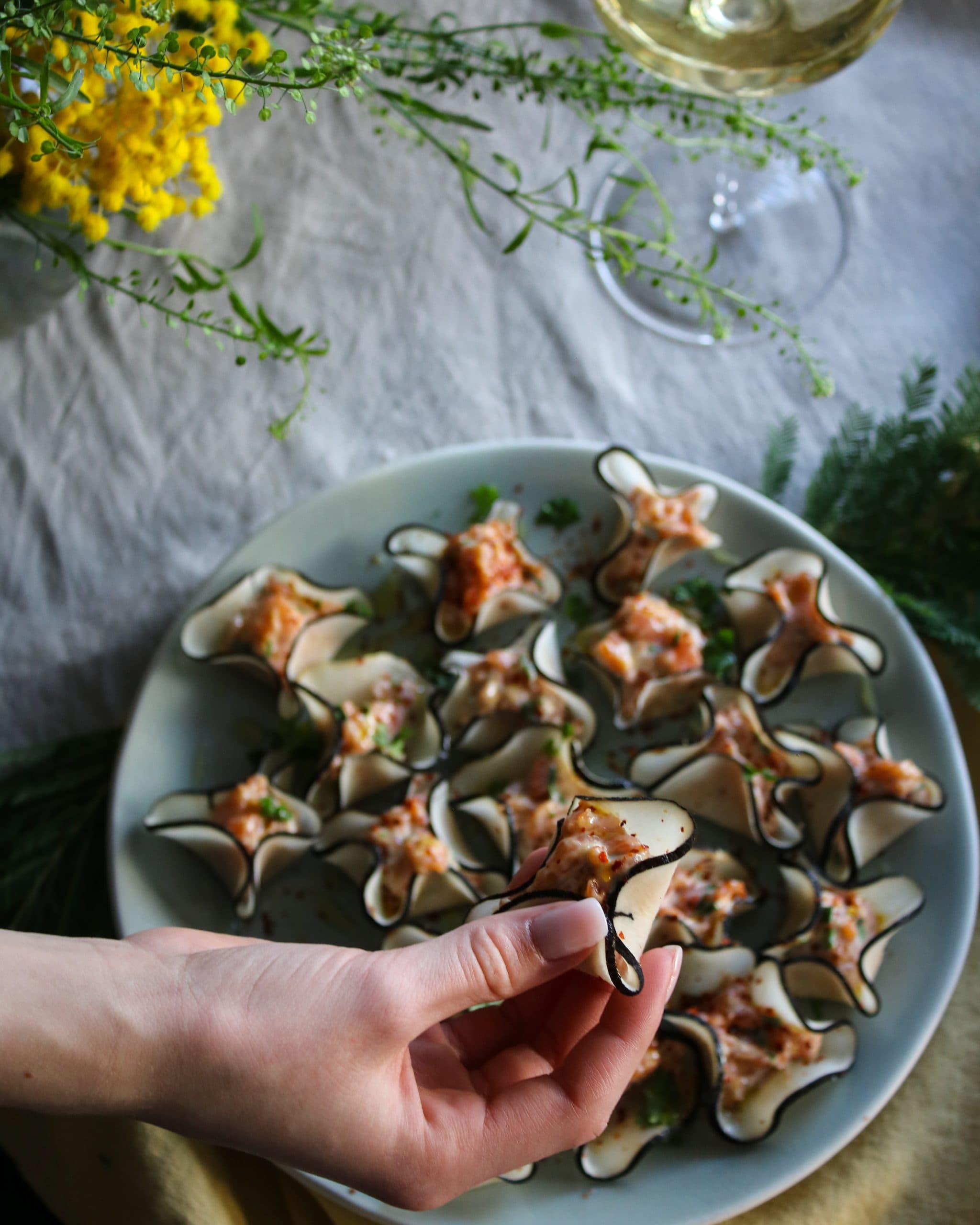 Skivor av svart rättika fyllda med rökt lax och toppade med miso- och citronmajonnäs.